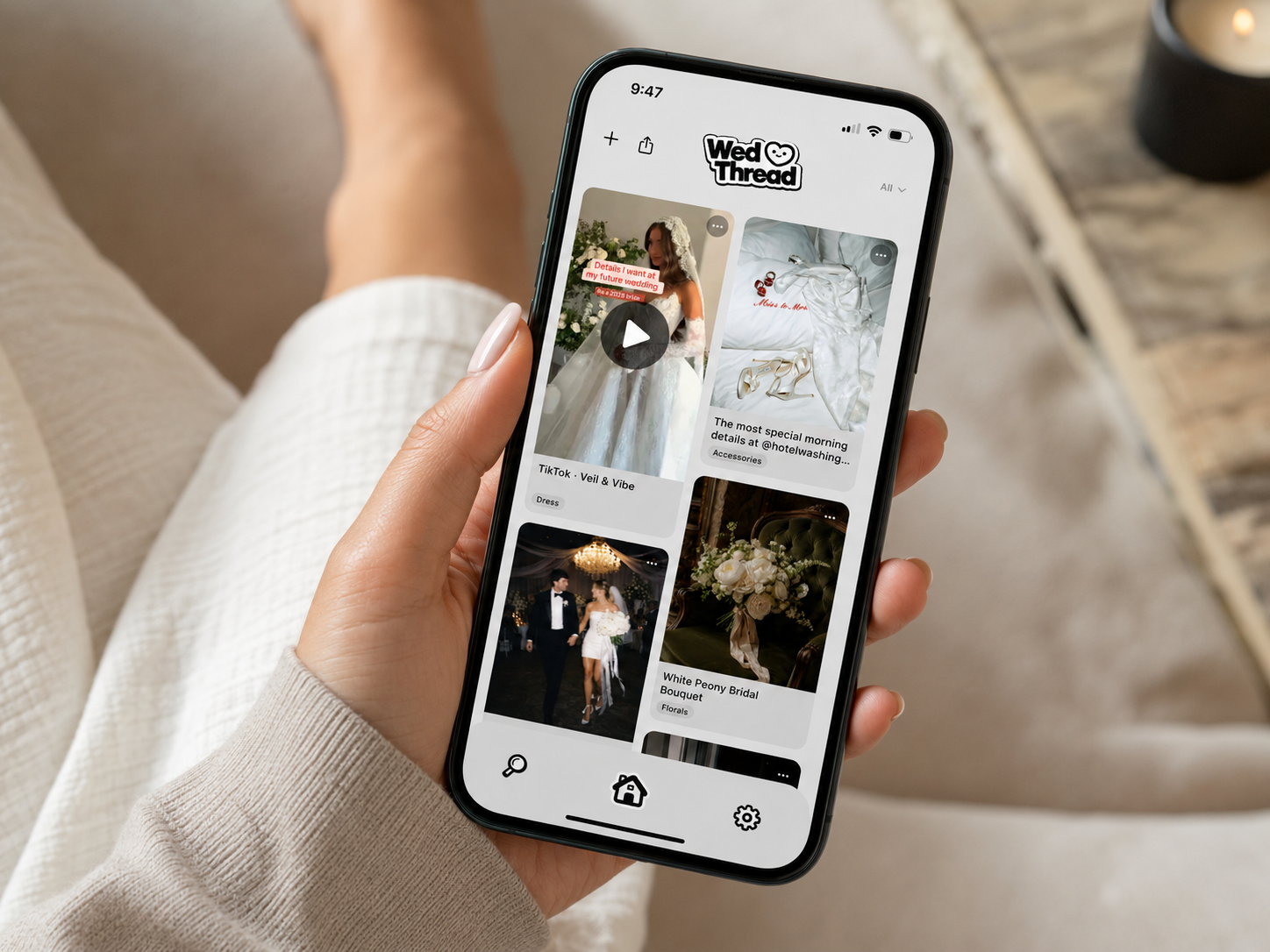 Bride holding her phone showing the WedThread app feed of saved wedding inspiration